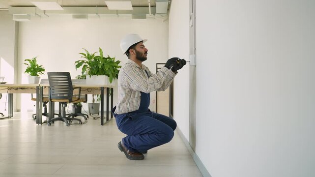 Professional electrician installing a wall socket