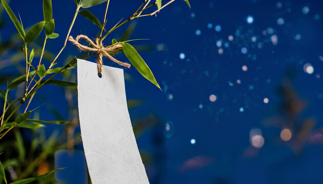 星空の下で風に揺れる七夕の笹と真っ白な短冊 / Tanabata bamboo and blank paper strip under a starry night sky (Generative AI)