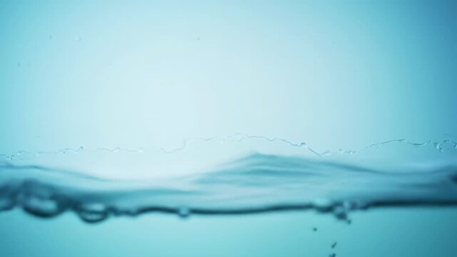 Pristine cgi animation of crystal clear blue water gracefully rising, forming ripples and waves, then becoming mirror-like on a soft light blue gradient background. Fluid dynamics concept