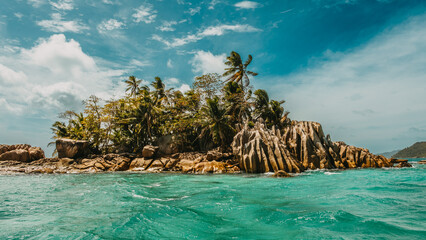 Granite boulders with palm trees on St. Pierre Island surrounded by turquoise ocean, Seychelles. © Maurizio De Mattei