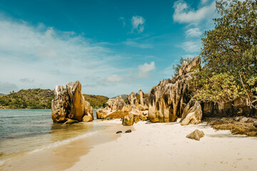 High granite boulders on white sand beach beside turquoise ocean at Baie Laraie, Curieuse Island, Seychelles. © Maurizio De Mattei