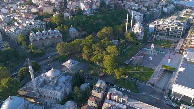Aerial shot of Tophane Park in Istanbul, featuring the historic Nusretiye Mosque, the Kilic Ali Pasa Mosque complex, and the Tophane Clock Tower surrounded by green trees and urban architecture.