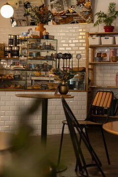 interior of chic city cafe with white tile wall and pastry case