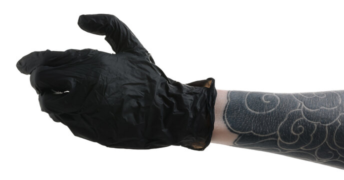 Woman with tattoos wearing glove and holding something on white background, closeup