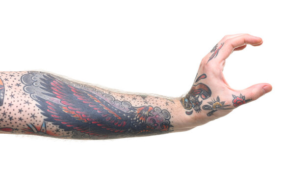 Man with tattoos holding something on white background, closeup