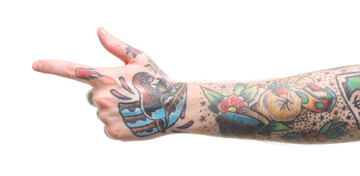 Man with tattoos pointing at something on white background, closeup