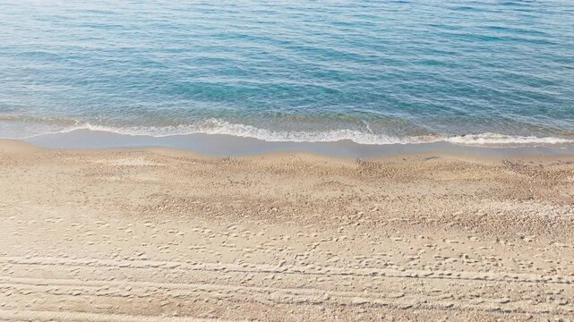 Sea with slow waves in Sicily deserted beach in summer relaxing refreshment