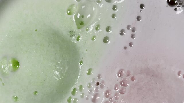 Bath bomb bubbles expand and multiply creating surreal graphic element