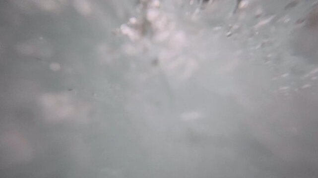 Rapidly displacing bubbles in water creates liquid themed background plate