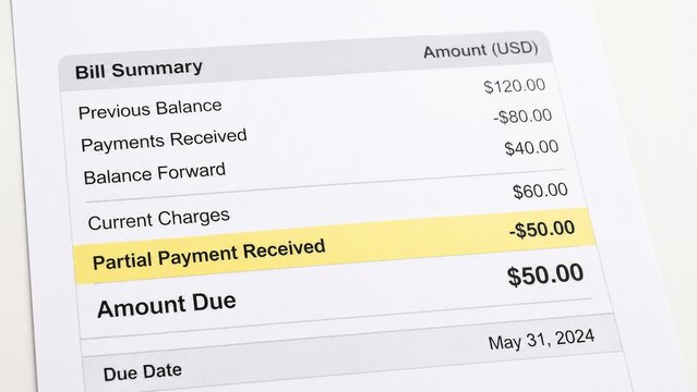 Close-up of bill summary showing partial payment received highlighted with amount due by may 31, 2024. concept of finance, payment tracking, expense management