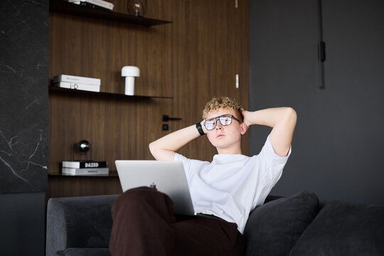 Young caucasian man content creator planning video ideas on sofa