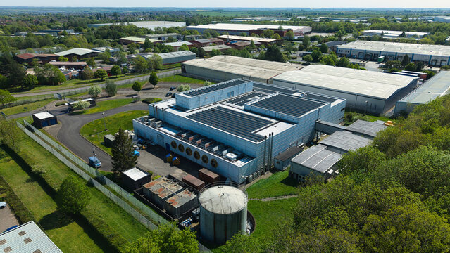 Aerial view of the Data Centre with solar panels on the roof and cooling systems in an industrial park in Wellingborough, England, United Kingdom.