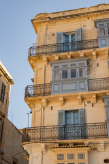 Obraz premium Epic traditional European town historic stone facade vertical panorama blue balconies. 
