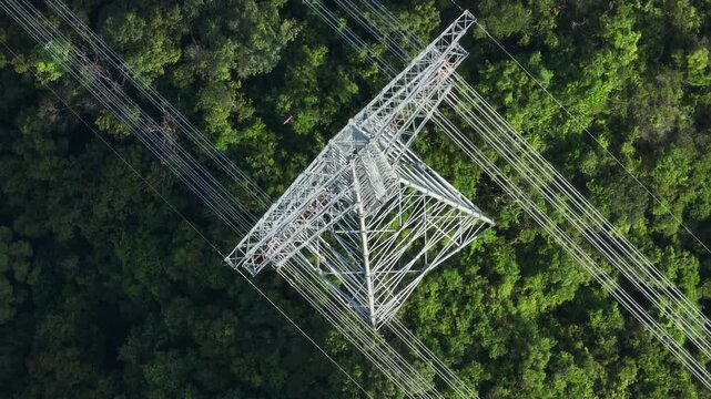 Aerial footage of High voltage line tower on mountain