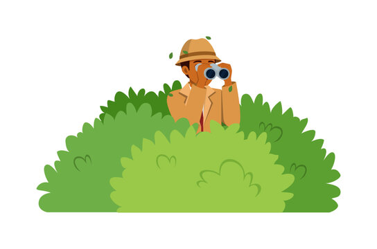 Brown-skinned man observing with binoculars peeking from green bushes in a curious and secretive manner