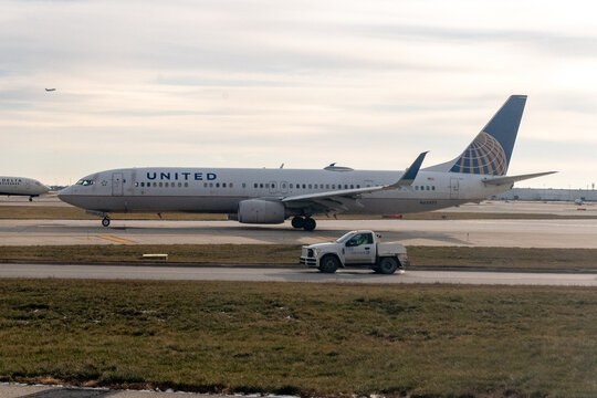 O'Hare Airport, Chicago, Illinois, USA - November 28, 2023 - United Airlines Boeing 737-Max NG jet N68805 is on the taxiway at Chicago O'Hare International Airport (ORD) with a service truck
