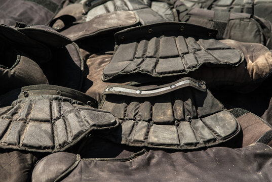 Old bulletproof vests and riot police helmets.