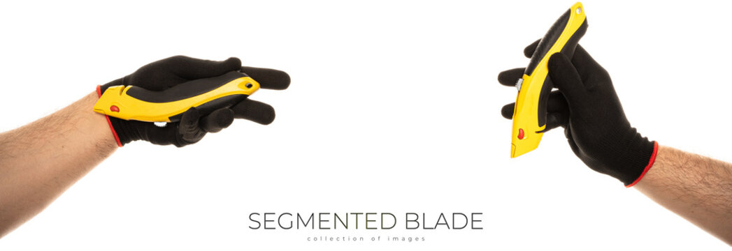 Segmented blade or snap-off blade utility knife in male hand isolated on white background.