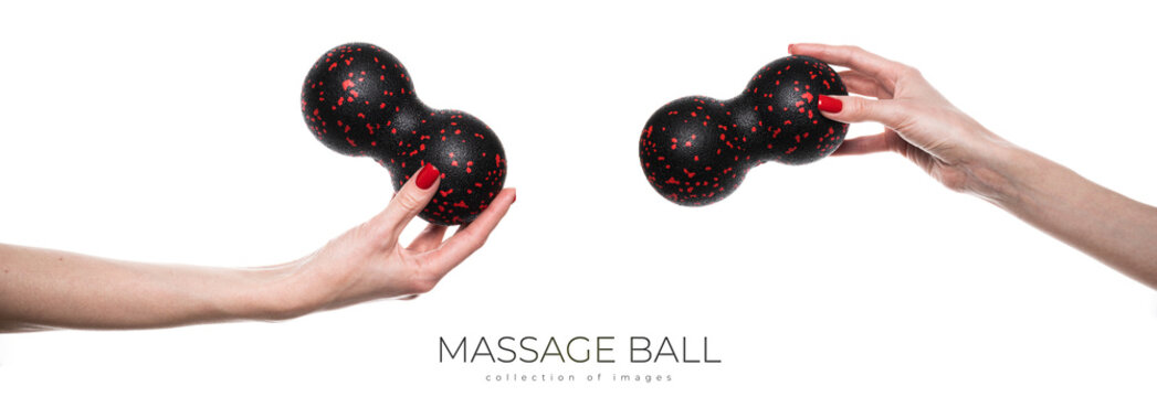 Black double ball or peanut ball massager in female hand. Sports equipment for fitness. Isolated on a white background
