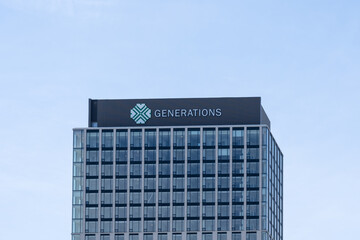 Naklejka premium Toronto, Ontario, Canada - April 26, 2026: Generations logo and sign on the building on Moriyama Drive, Toronto, Ontario, Canada. Generations Toronto is a not-for-profit, inter-generational community