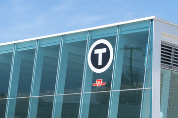 Naklejka premium Toronto, ON, Canada - May 4, 2026: The ttc logo on the building at Mount Dennis Station on the Eglinton Crosstown LRT (Line 5) in Toronto. Mount Dennis Station is an intermodal terminal serving GO Tra