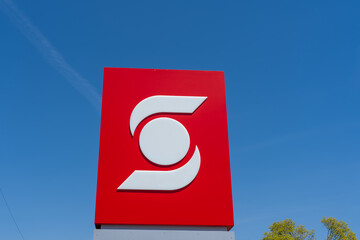 Naklejka premium Toronto, Canada - May 4, 2026: A close up of Scotiabank brand logo against blue sky. Toronto, Canada. Scotiabank is a Canadian multinational bank.