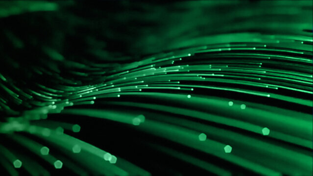 An abstract digital wallpaper featuring green and blue fiber optic lines that glow with bright energy to illustrate a motion-filled wave of optical communication technology and art