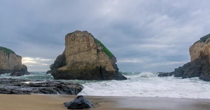 Shark Fin Cove under shifting cloudy skies
