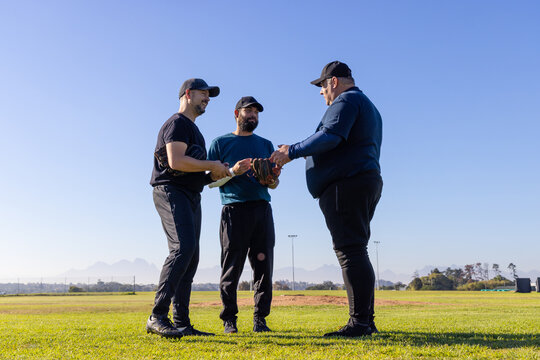 Three teammates exchanging baseball starting drill showing animated trajectory around glove