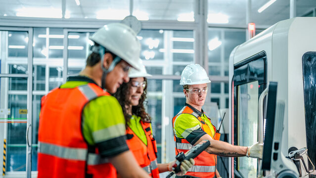 team of engineers uses an AI-driven smart factory for advanced manufacturing. This future of work technology optimizes the supply chain and production efficiency for high-tech growth.