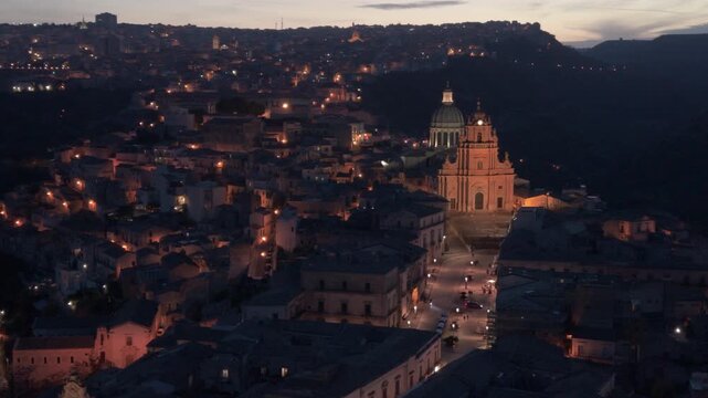 wider evening flying counter clockwise view of historic Ragusa Sicily