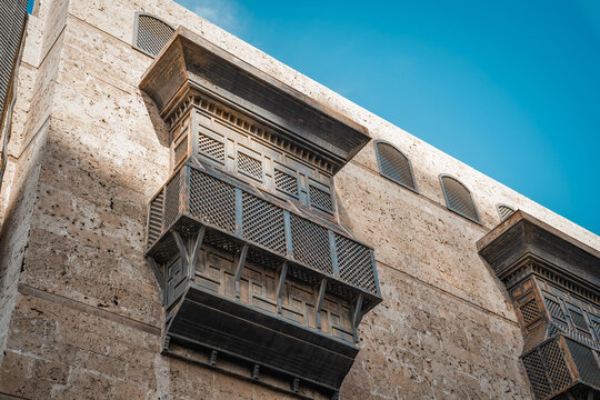 Street view of historic Al-Balad district in Jeddah, Saudi Arabia, featuring traditional old shop houses and preserved heritage architecture.