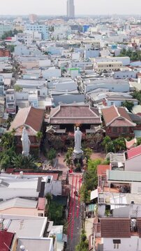 Vertical screen Temple Procession Route. Overview Of Festival Pathway. Aerial Perspective Of Ceremony Trail In Neighborhood. Can Tho Festival Route Featuring Statues And Decorative Ribbons