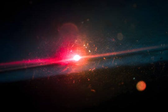 A light leak overlay effect featuring scratch dust and motion blurred light leaks. An abstract background with red rays and a grunge old film burn lens create a noisy film texture.