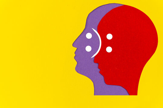 Abstract overlapping human head silhouettes with emotional duality icon,