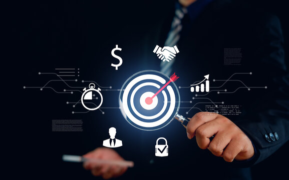 Businessman analyzing target with magnifying glass and business icons, representing financial growth, strategy, partnership, security, and performance optimization in digital business concept.