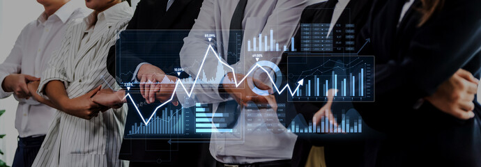 A diverse group of business professionals stands together in a modern office, with digital graphs and charts overlay representing financial data and strategic insights. Scalp © InfiniteFlow