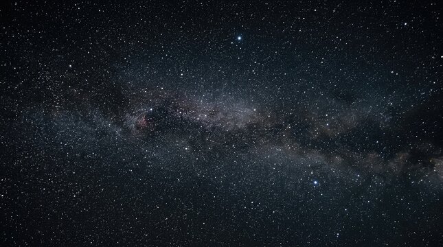Dense starfield and Milky Way band stretch across deep space on dark night sky.