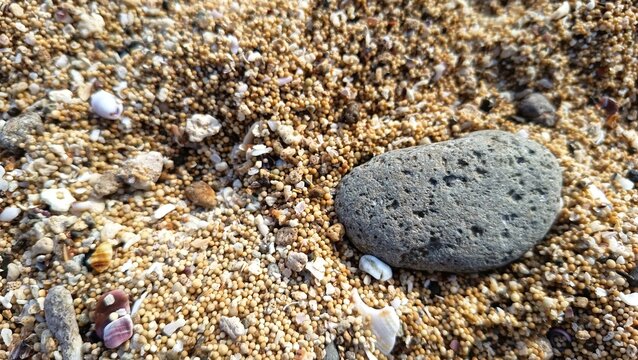 colorful beach sand mixed with tiny shells and pebbles 
