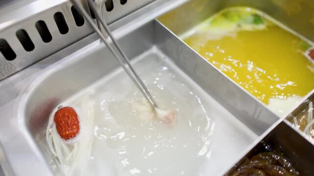 Traditional Chinese Hot Pot with Boiling Broth and Fresh Ingredients