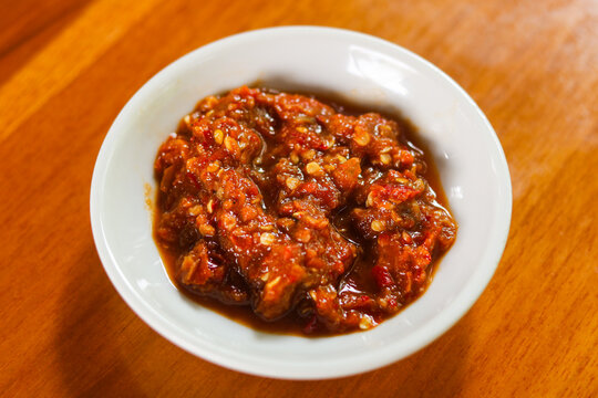 Closeup of a bowl of authentic Indonesian Sambal Terasi, a bold and fiery chili paste enriched with fermented shrimp paste.