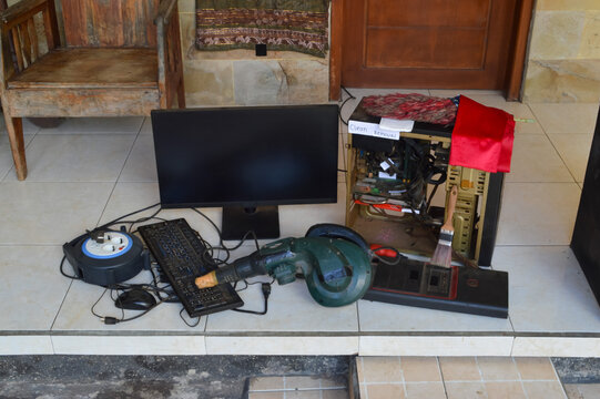 Center extreme high angle shot capturing a complete computer cleaning setup including a blower, brush, and disassembled CPU components.