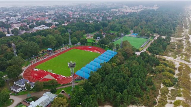 Drone turns right focusing on Liepaja Daugava stadium and secondary field