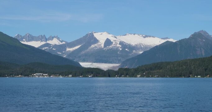 Sunny summer day in Juneau, Alaska.Mendenhall Glacier and the surrounding mountains covered by snow.