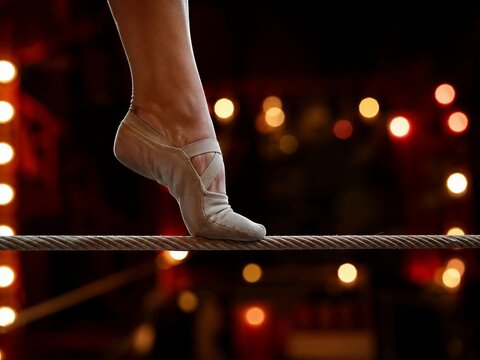 Balancing Act on a Tightrope at Night