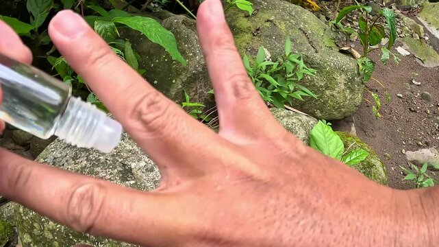 A leech is sucking a man's blood. The leech is clinging tightly to the spaces between his fingers.