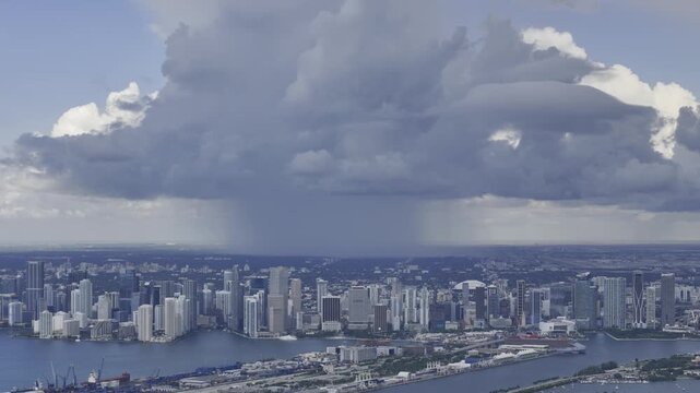 Aerial skyline of Miami Beach, Florida at sunset with bay, highrise buildings and dramatic clouds. g.