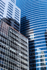 Fototapeta premium Architecture reflection. Building architecture. Building background. Glass building window. Architectural detail. Background of architecture. Modern glass background. Reflective glass background