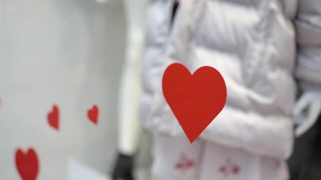 Heart sticker on store window with display behind