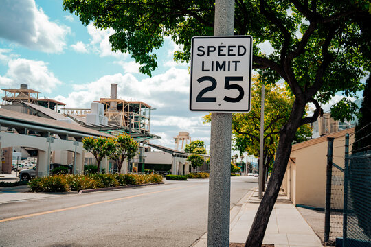 Street scene with a speed limit 25 sign and industrial buildings in the background